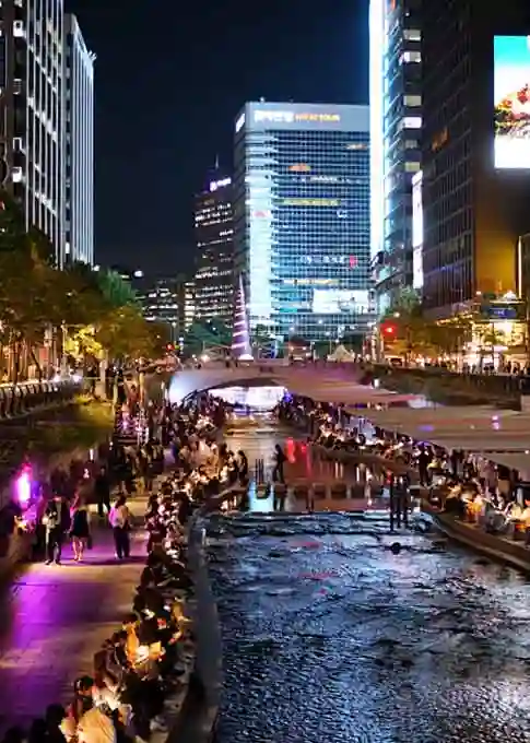 Reading a Book While Listening to the Sound of Flowing Water and the Tall Buildings of Seoul